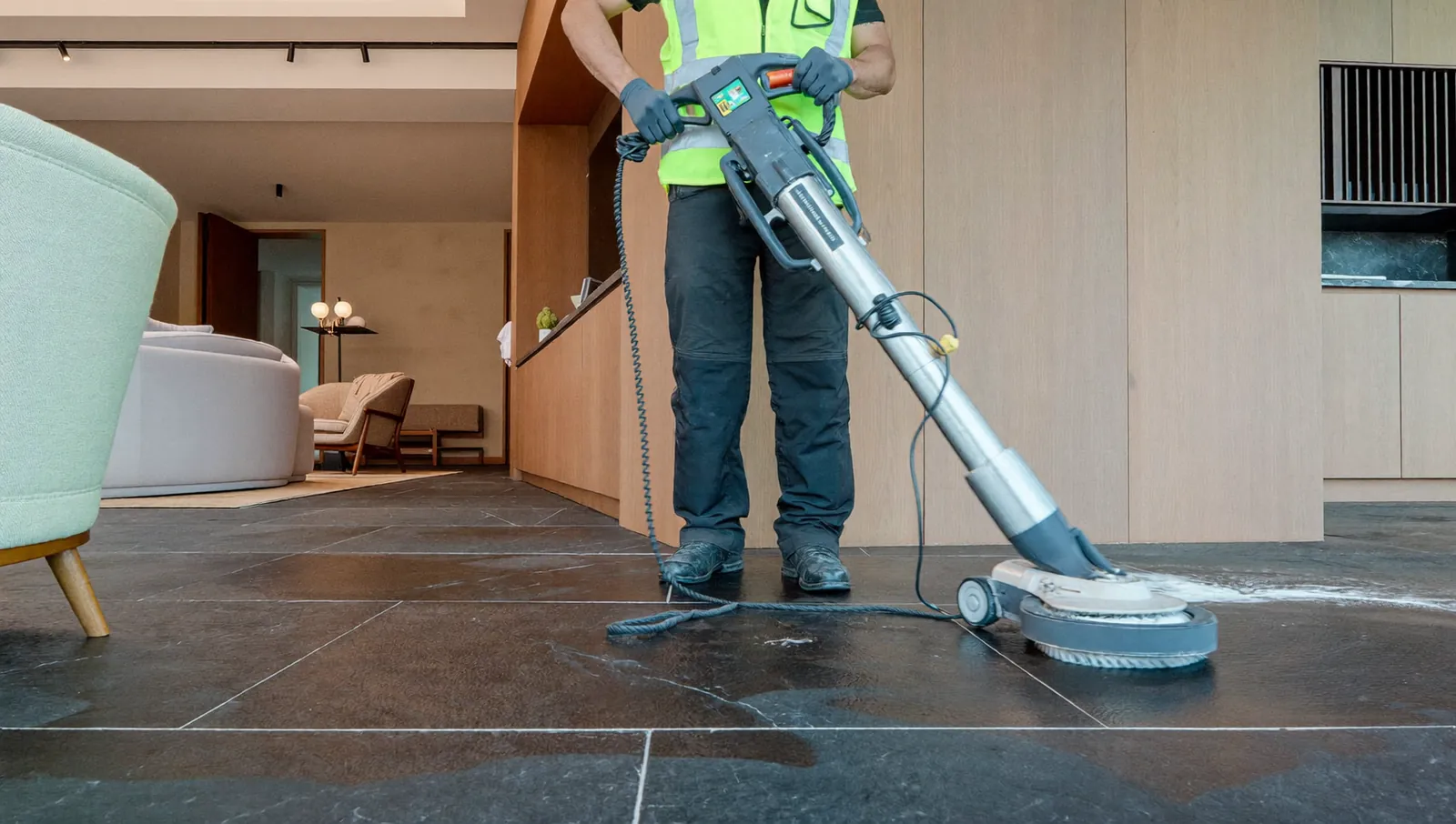 Specialist inspecting a slate floor before cleaning and sealing