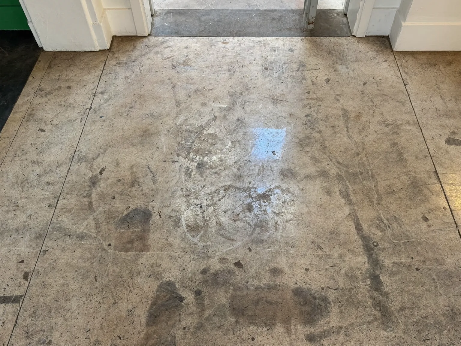 Dull and scratched terrazzo floor in a London period home before professional polishing and restoration