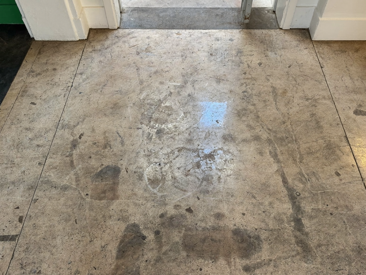 Dull and scratched terrazzo floor in a London period home before professional polishing and restoration