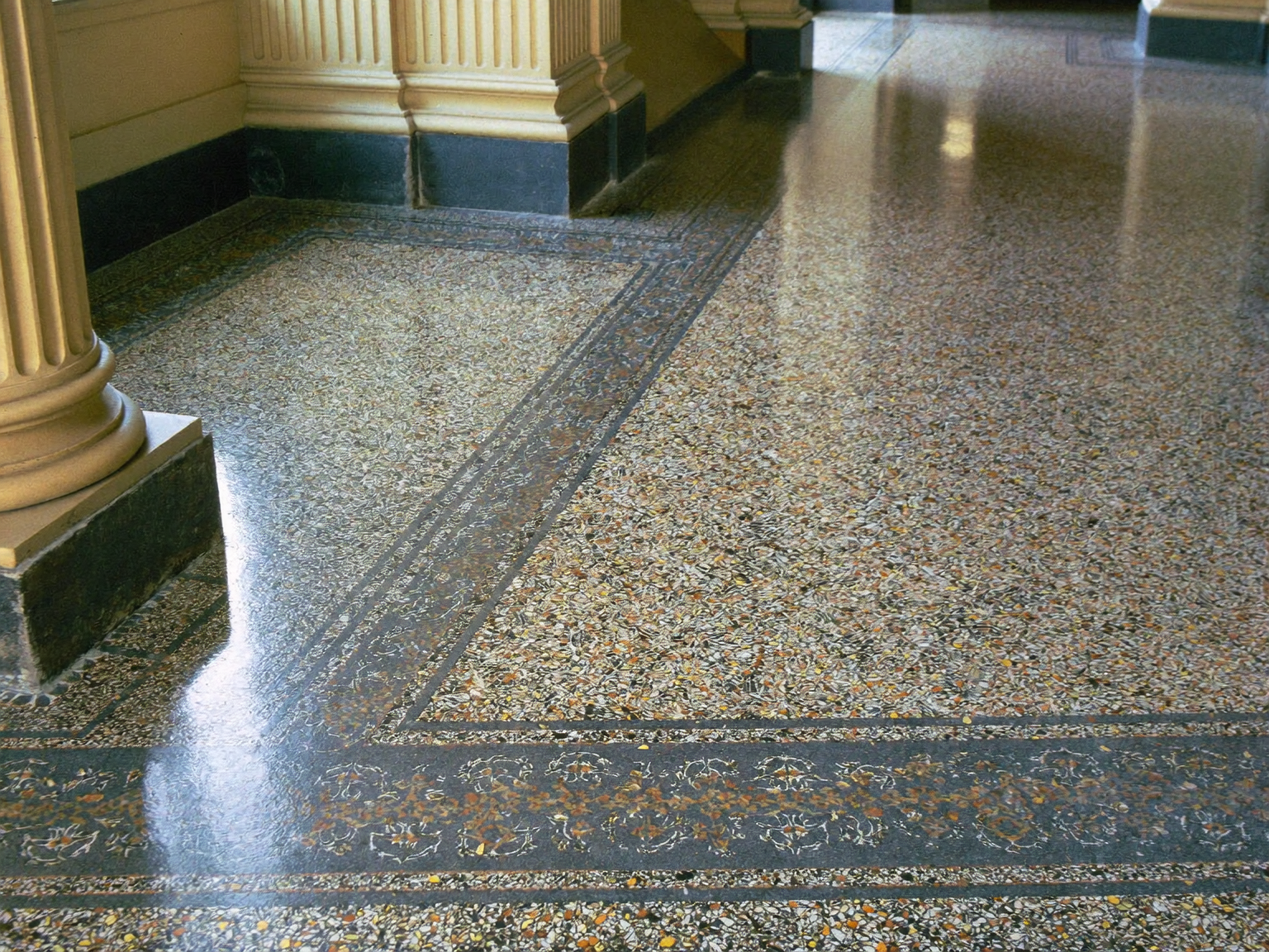 Restored terrazzo floor with decorative border in a listed London heritage building